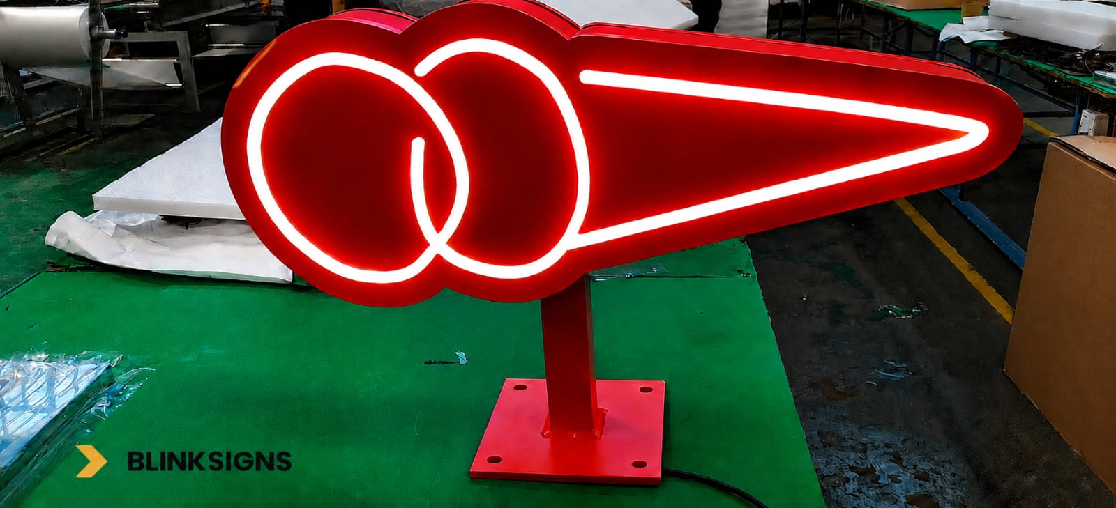 Custom illuminated red ice cream cone blade sign completed and tested in manufacturing warehouse of BlinkSigns