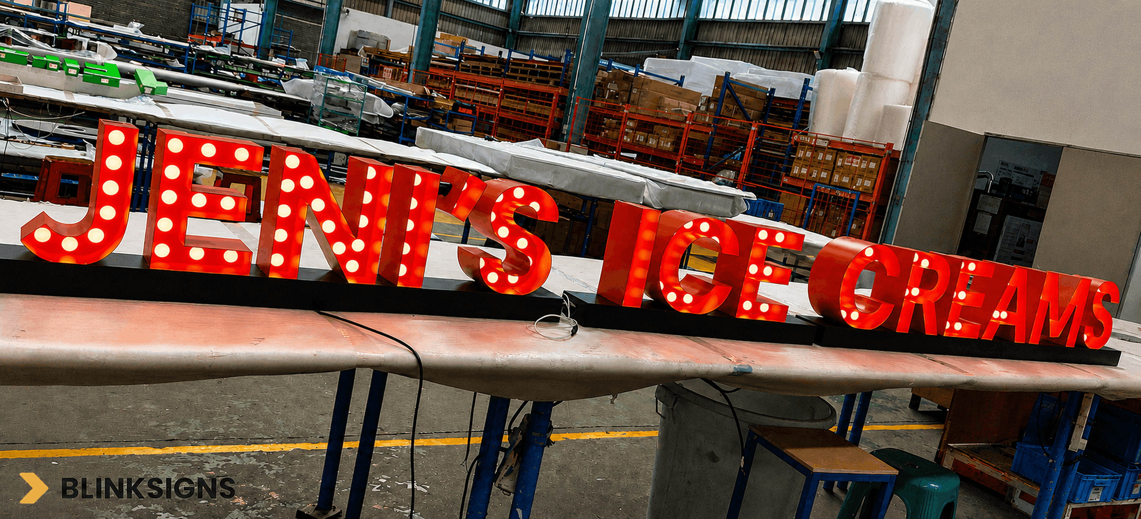 Custom red marquee front-lit channel letters undergoing electrical testing in fabrication facility of BlinkSigns