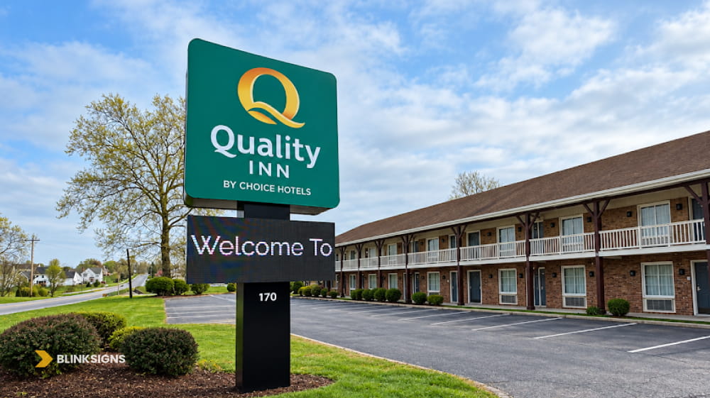 Quality Inn roadside pylon sign featuring an integrated programmable digital LED electronic message center board.